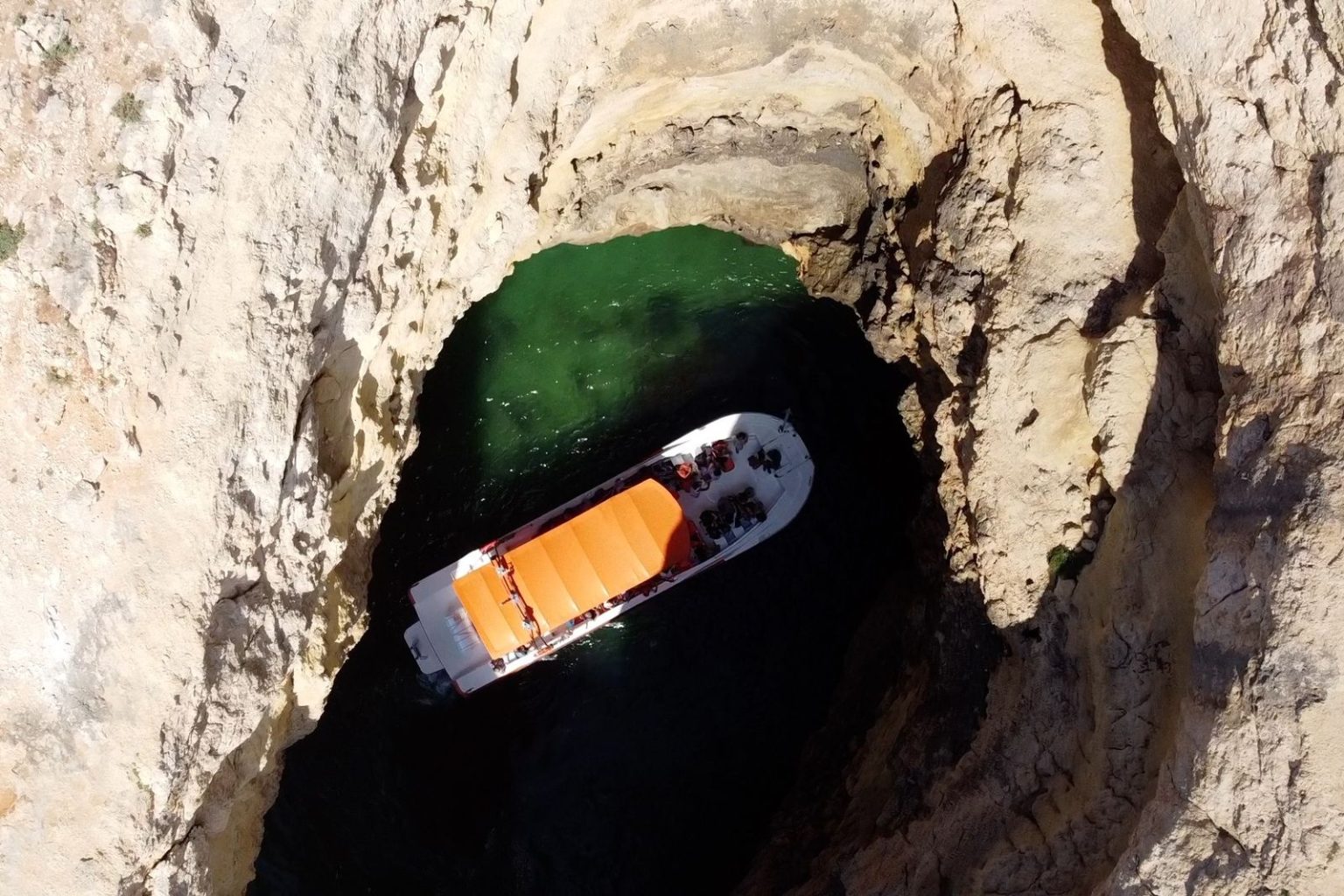 Aerial view of a boat inside a sea cave