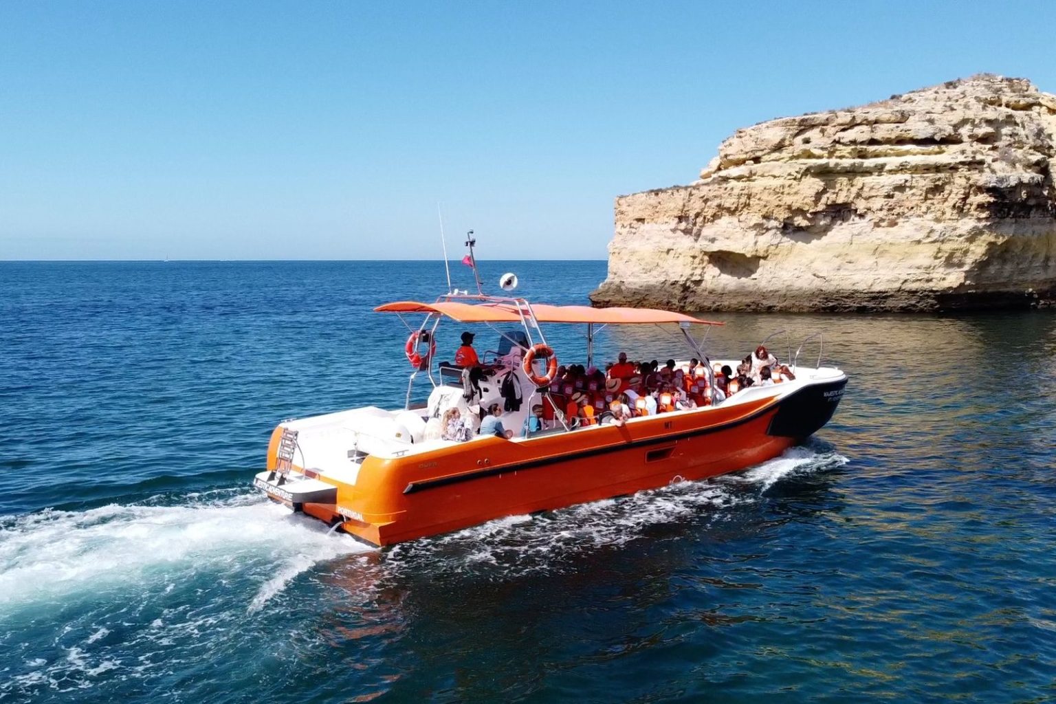 Cruise boat passing a rock stack near Albufeira