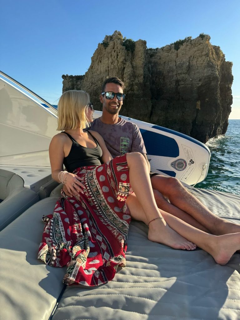 Couple relaxing on the sunbed of a yacht