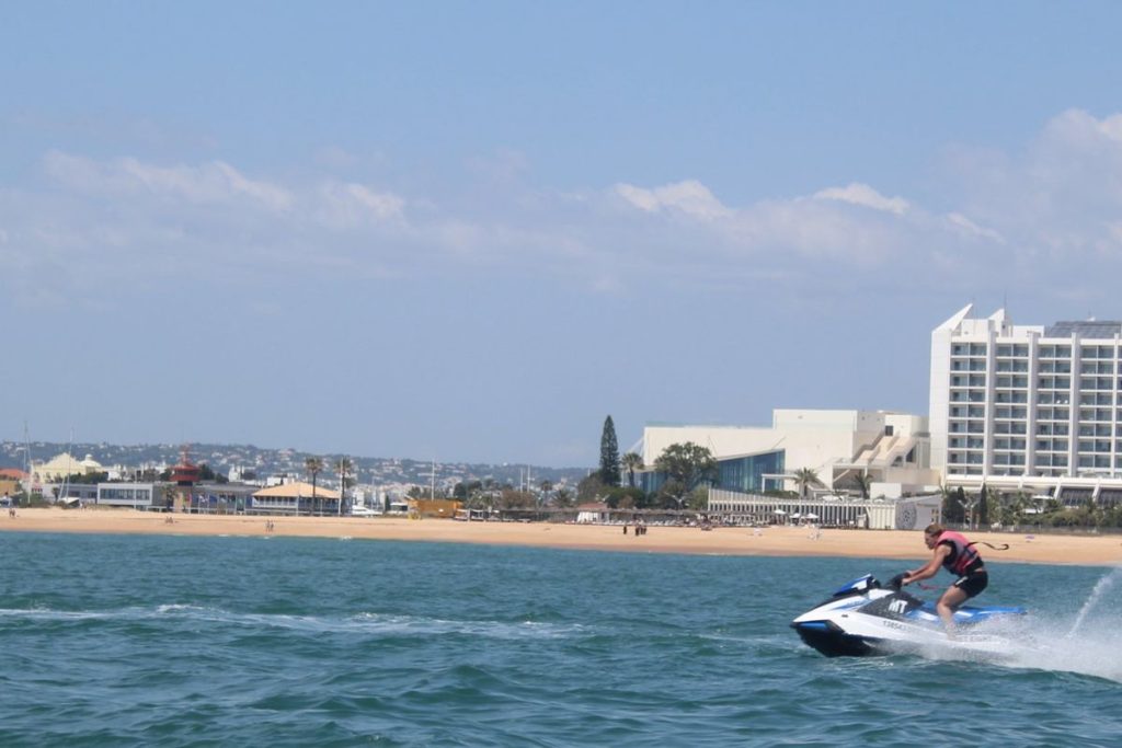 Woman riding a jet ski in front of the Tivoli Marina Vilamoura