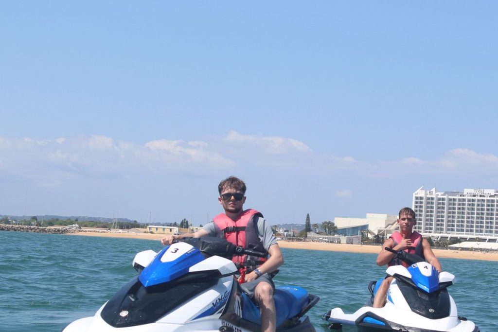 Two jet skis riding side by side off Vilamoura beach