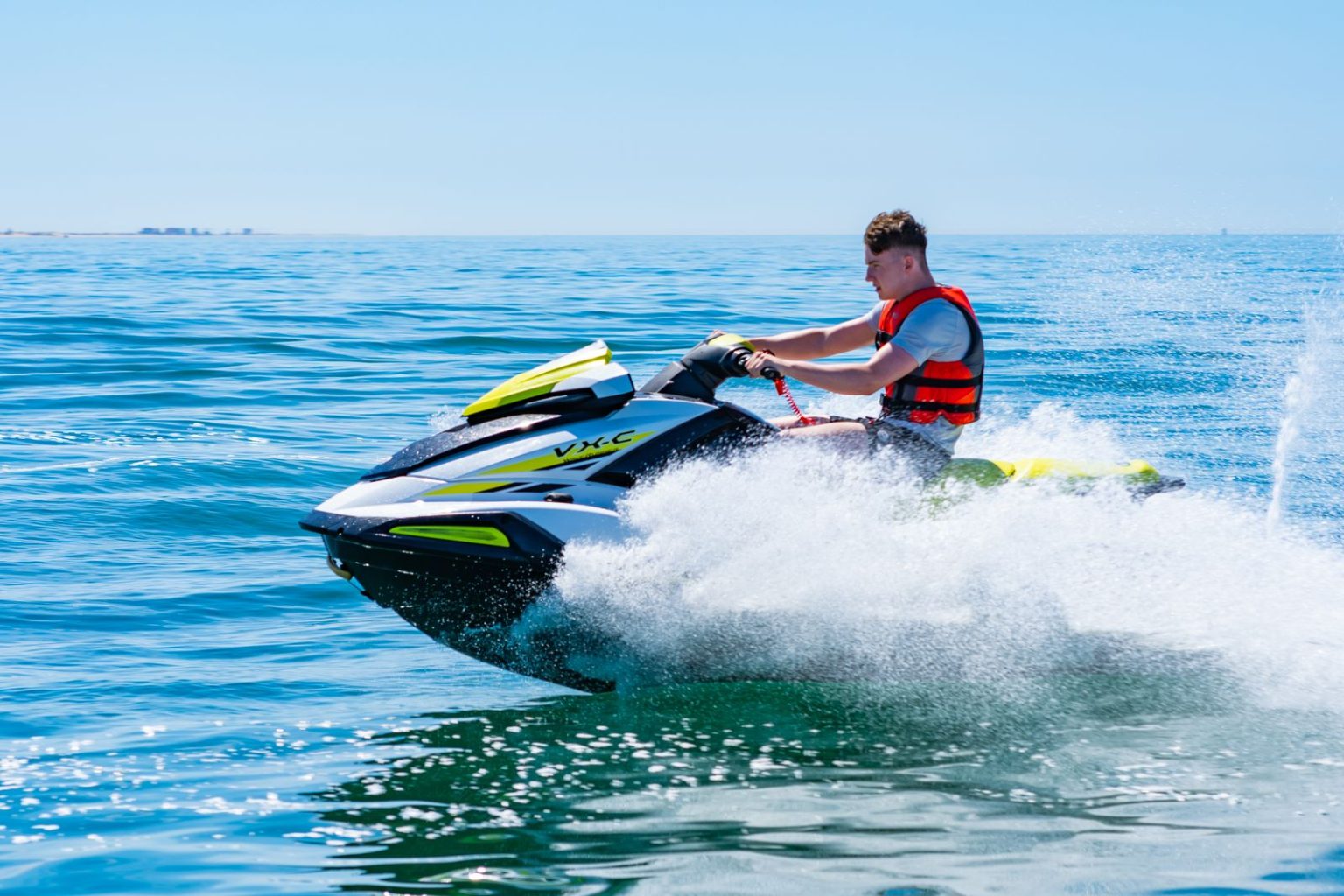 Rider leaning into a fast turn on a jet ski