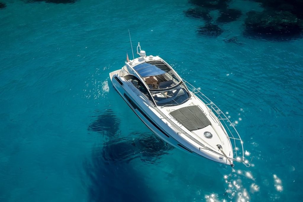 Aerial view of a private motor yacht on the blue sea