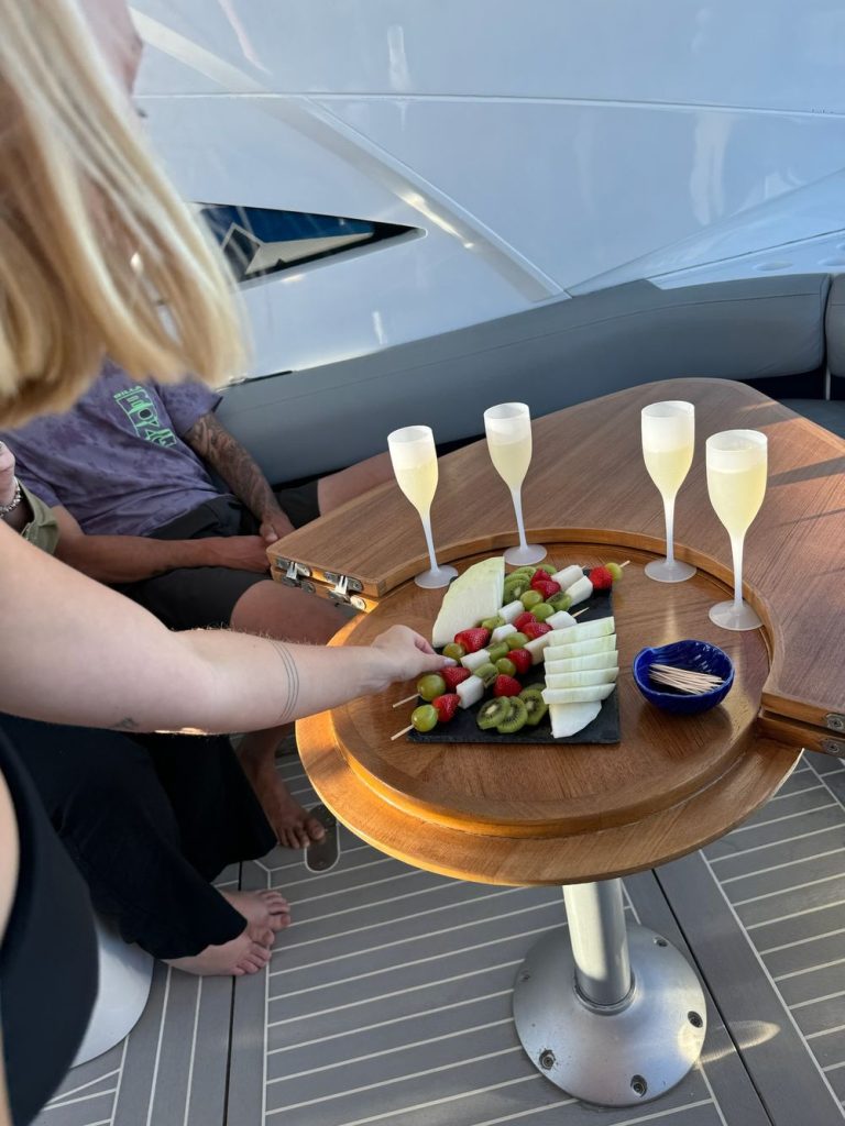 Champagne and a food platter on a yacht deck