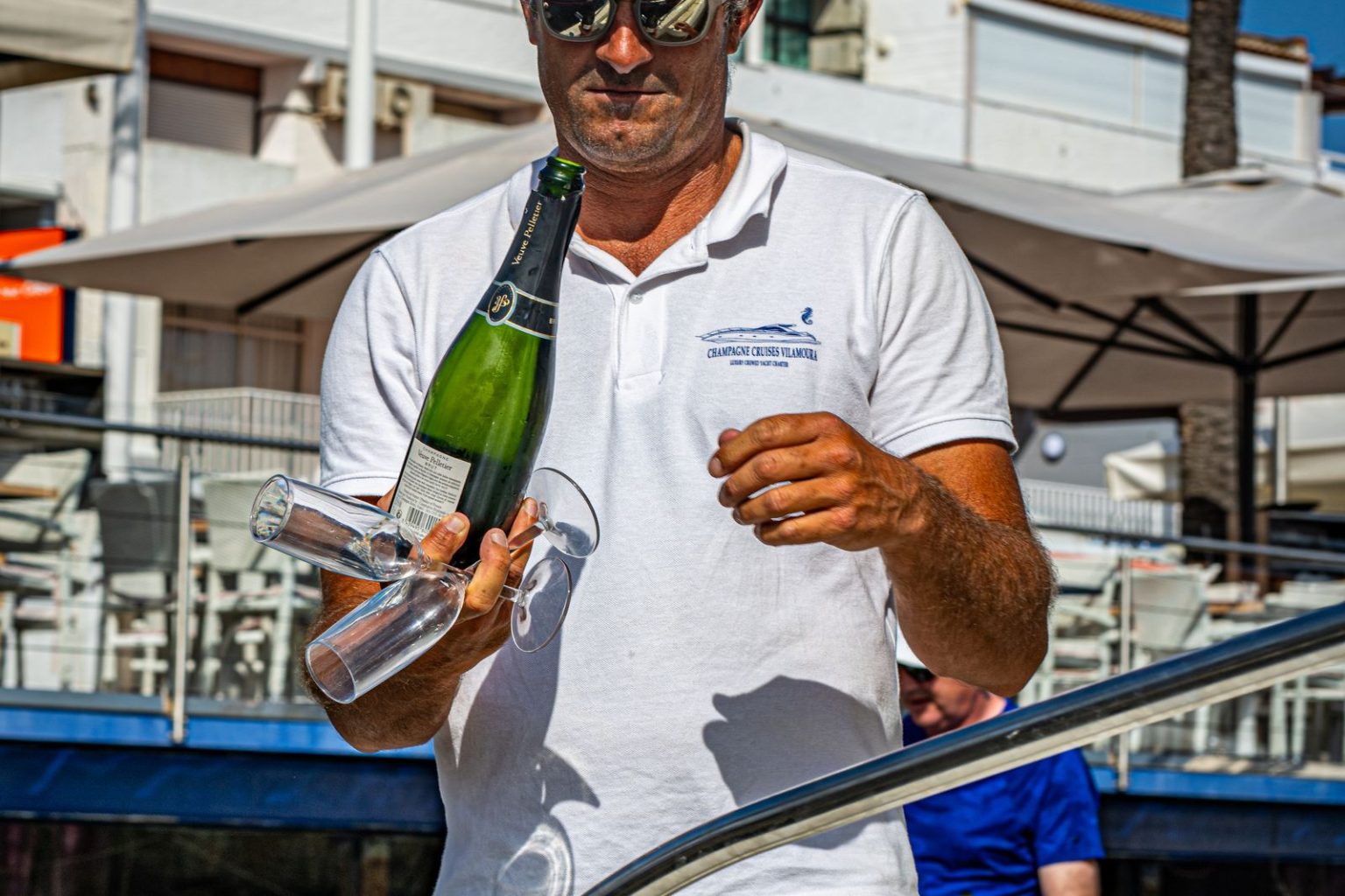 Skipper welcoming guests on board with champagne